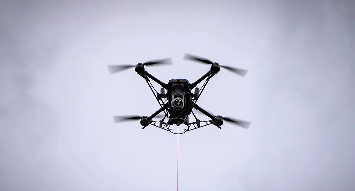 Underside view of Hoverfly’s Spectre 2.0 drone during tethered flight, showing the central section and suspension system