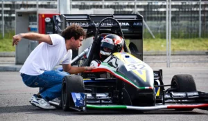 A moment of rest and discussion during a track testing session ahead of the Michigan trip